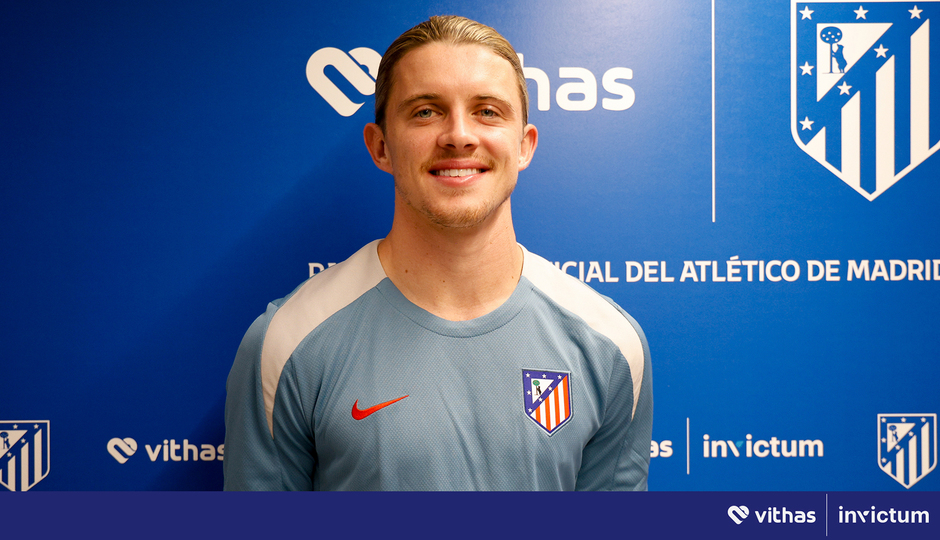 a man stands in front of a blue wall that says invictum