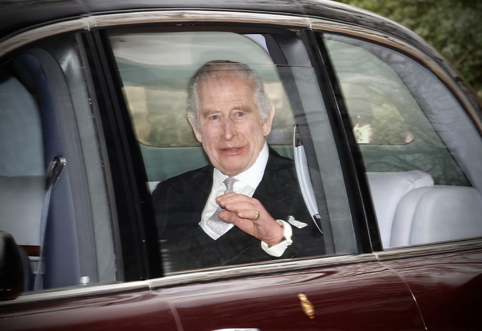 a man in a suit and tie is sitting in a car