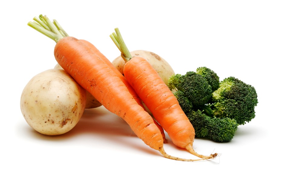 carrots potatoes and broccoli on a white background