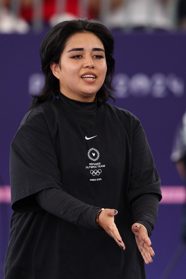 a woman wearing a black shirt that says olympic games on it