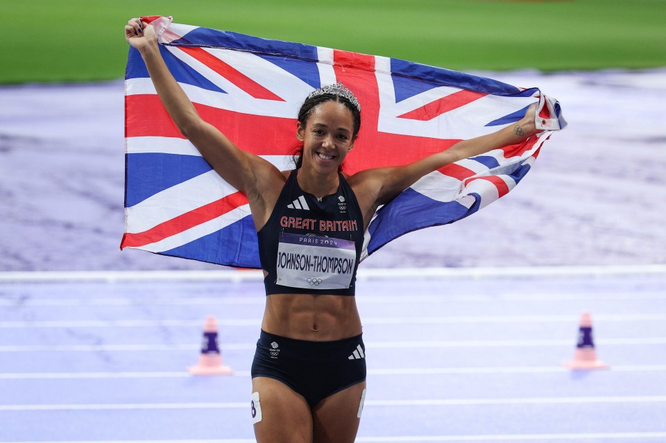 a woman holding a flag that says great britain on it