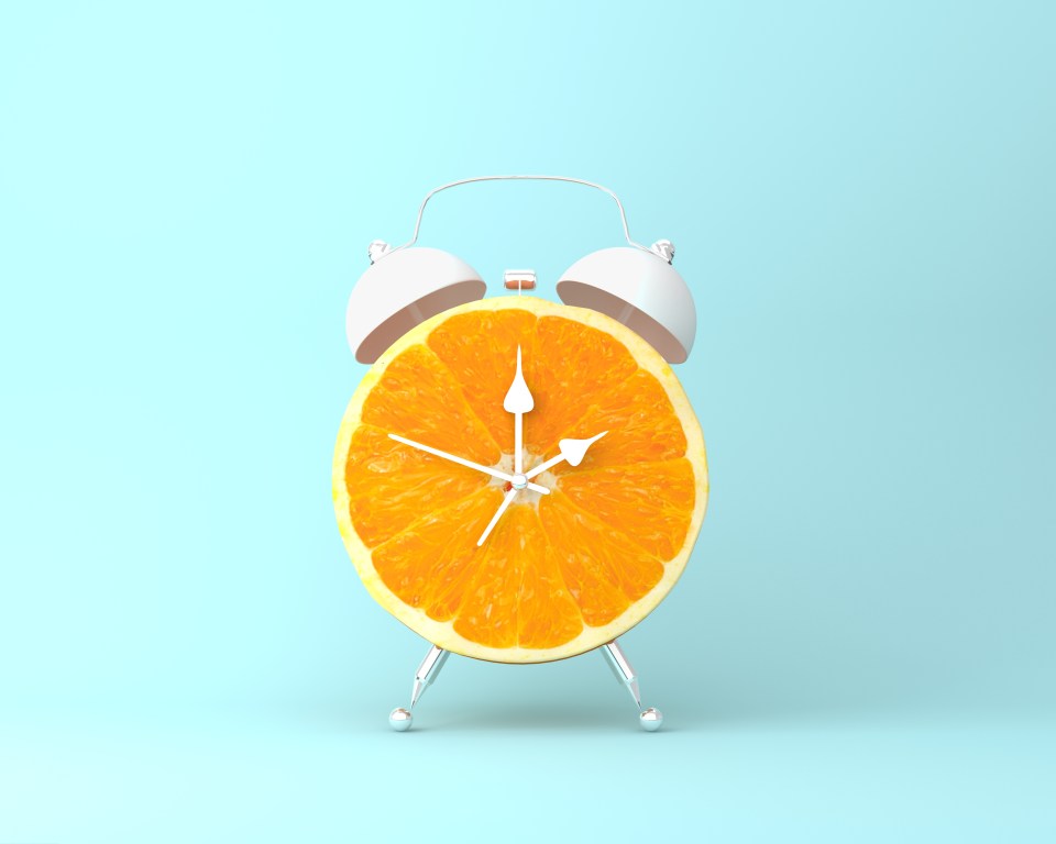 an alarm clock made out of an orange slice