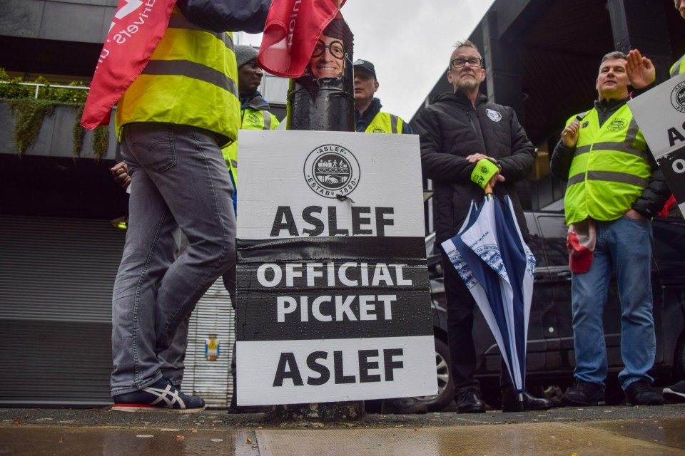 a group of people holding signs that say aslef official picket