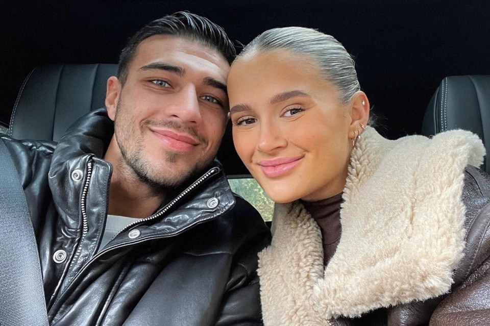 a man and a woman are posing for a picture in a car