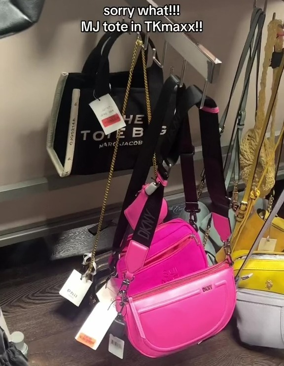 a display of handbags including a marc jacobs tote bag