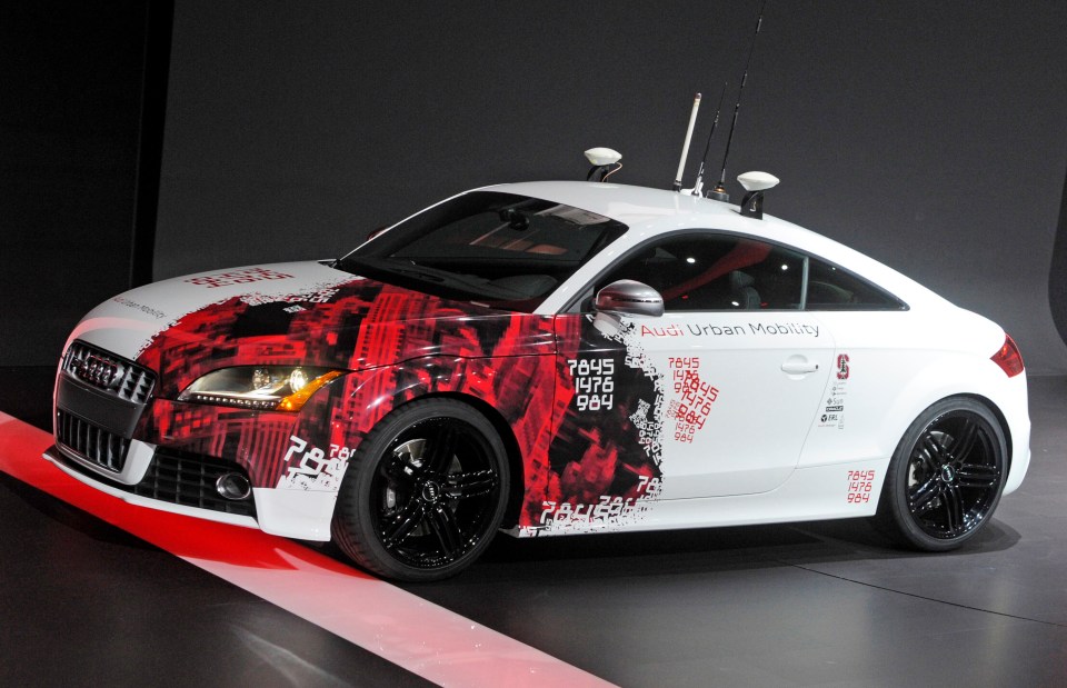 a white and red audi urban mobility car on display