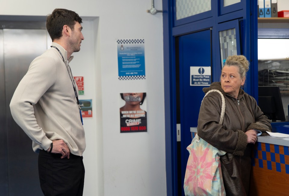 a man stands next to a woman in front of a sign that says crime stoppers