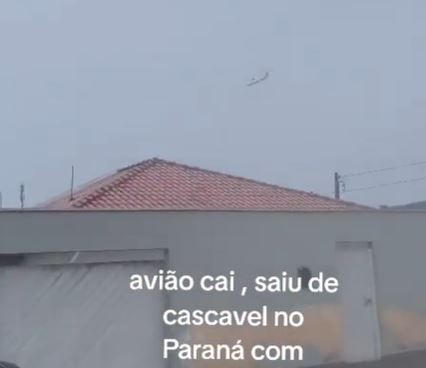 a plane is flying in the sky over a house .