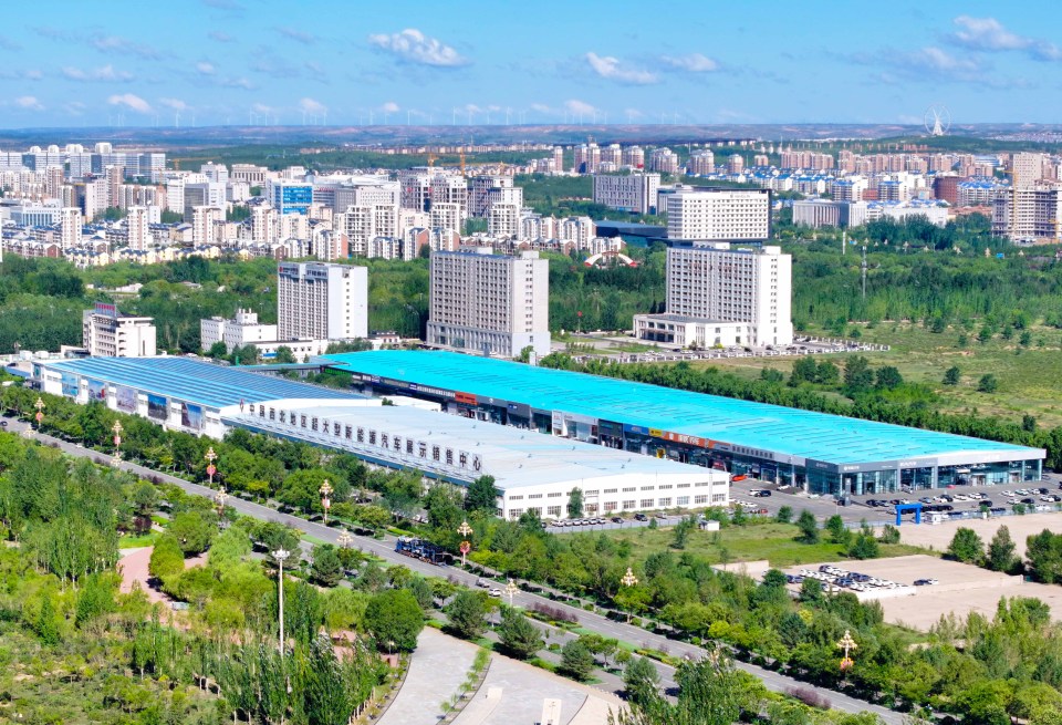 an aerial view of a city with lots of buildings and trees