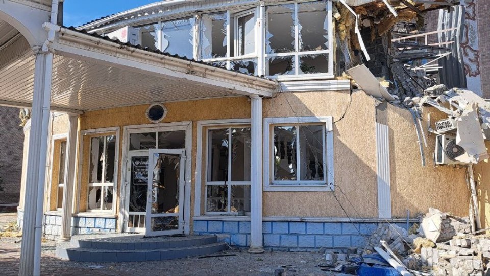 a damaged building with a sign that says ' apollo ' on it