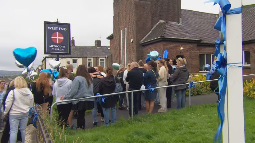 Dozens gathered outside the local church to pay their respects to Jay Slater with blue balloons after his body was found in July