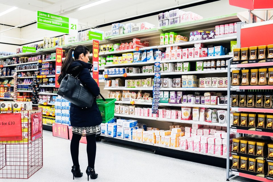 a woman is shopping in the juice and cereals section of a store