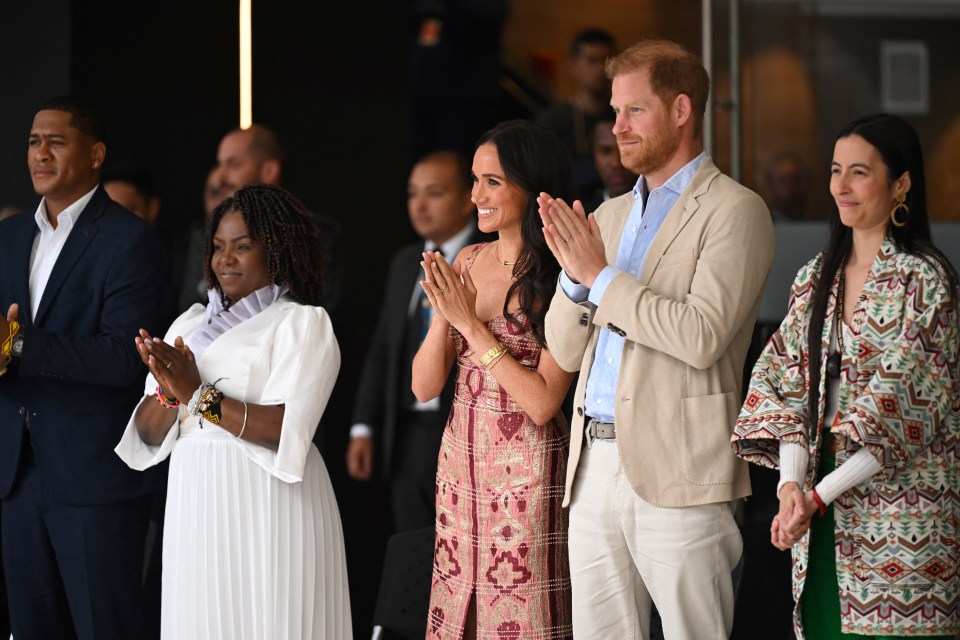 a group of people standing in a line with their hands together