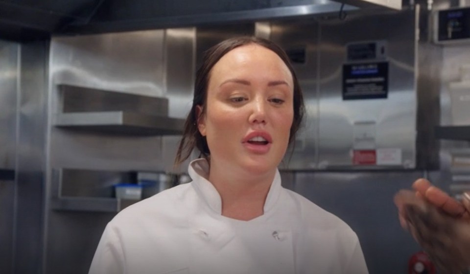 a woman in a chef 's coat is talking to a man in a kitchen with bbc written on the bottom