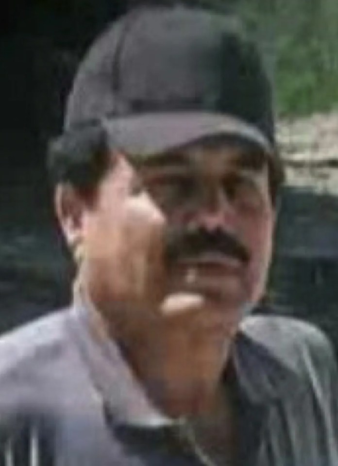 a man with a mustache is wearing a black hat .