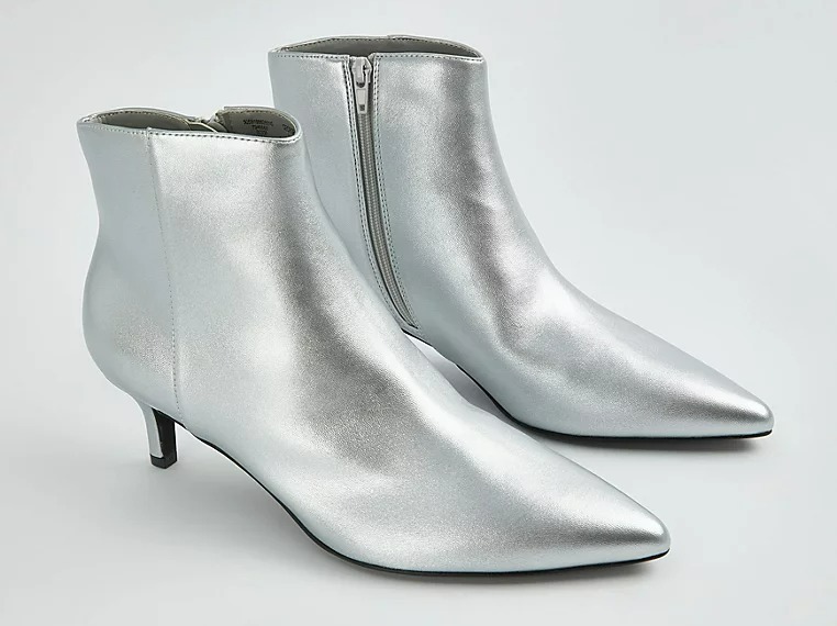 a pair of silver boots with pointed toes and a kitten heel