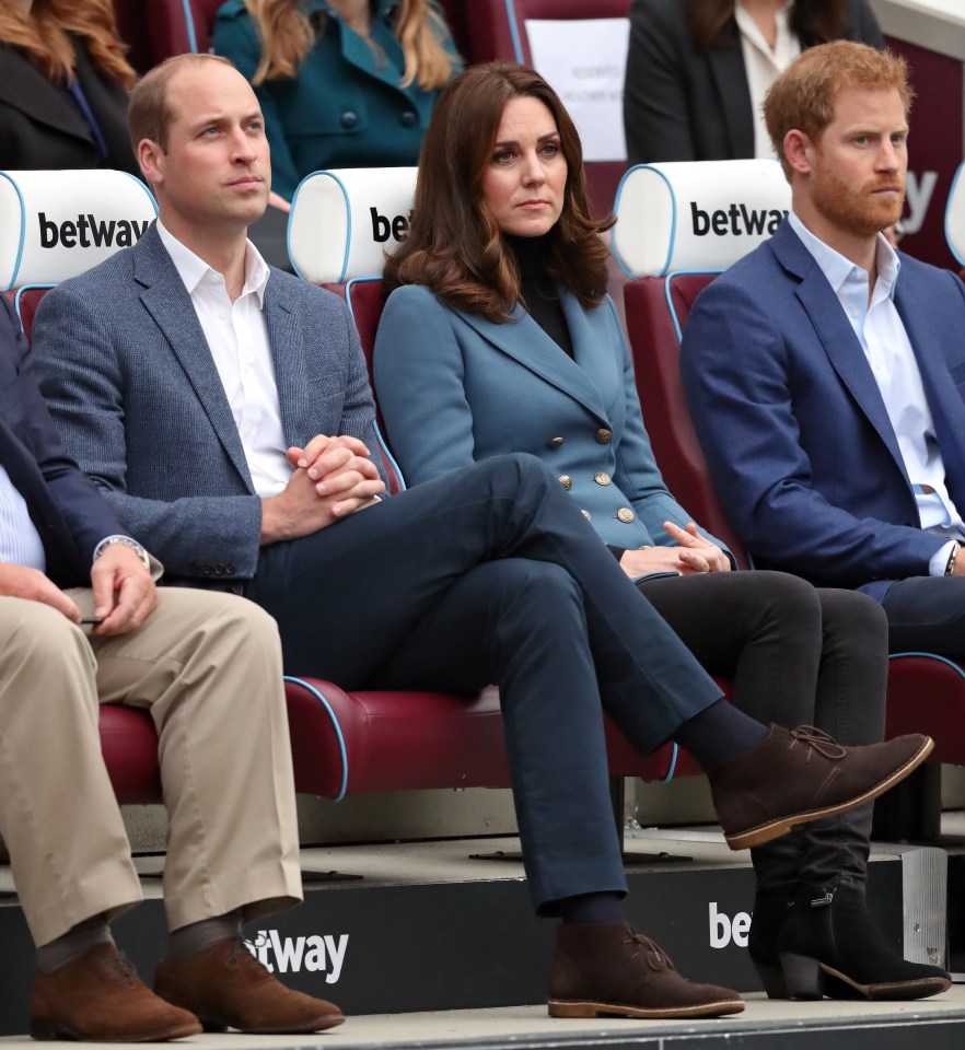 a group of people are sitting in a stadium with seats that say betway