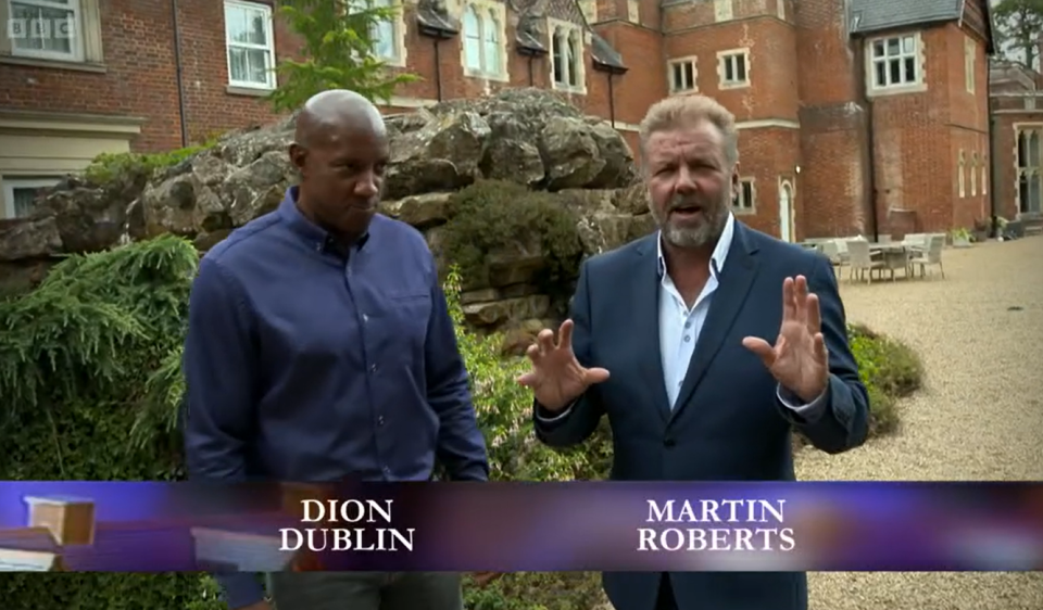 martin roberts and dion dublin are standing in front of a brick building