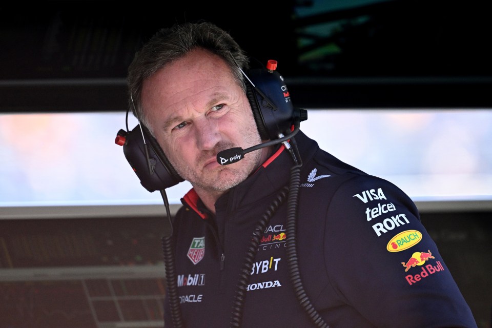 a man wearing headphones and a red bull shirt