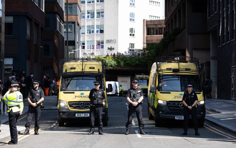 Police officers guard the exit to Liverpool Magistrates Court