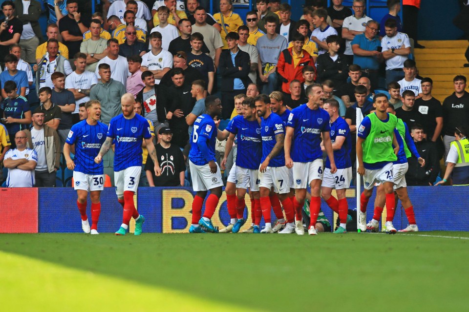 a group of soccer players wearing blue jerseys with the number 5 on them