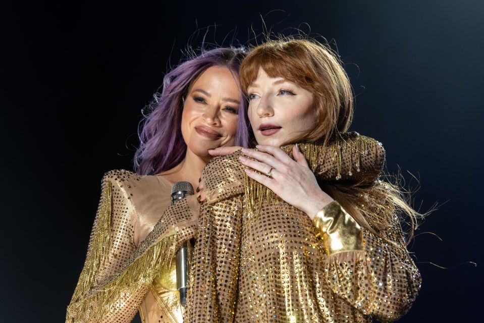 Nicola Roberts, pictured with Kimberley Walsh, has revealed she is engaged — by showing off her ring on stage