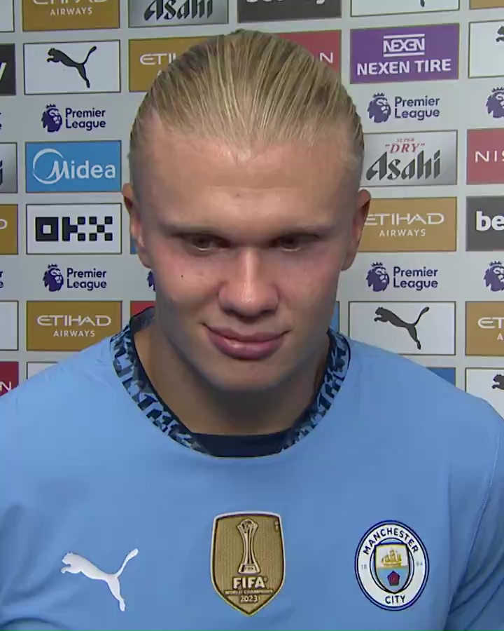 a man wearing a blue manchester city jersey