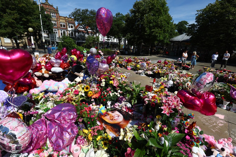 a bunch of flowers and balloons with one that says ' i love you ' on it