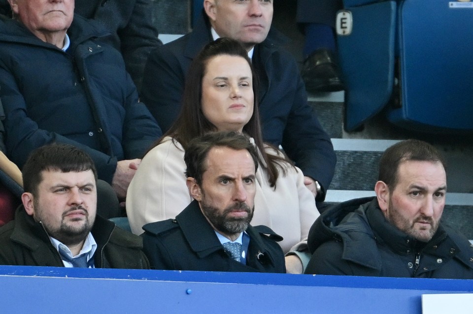 a group of people sitting in a stadium watching a game