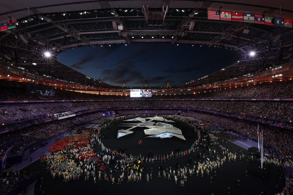 an empty stadium with purple seats and a banner that says ' allianz ' on it