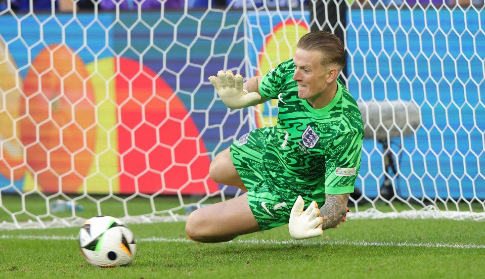 a soccer player wearing a green jersey with the number 1 on it