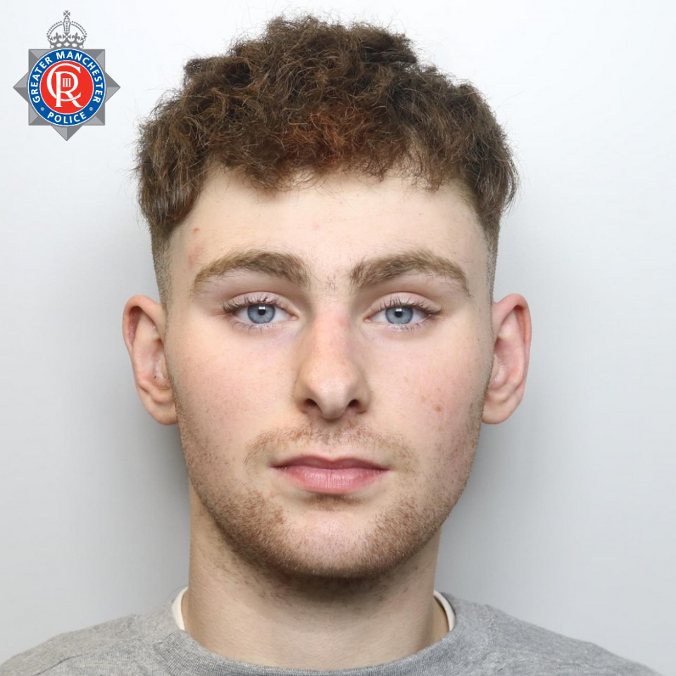 a young man with blue eyes and a greater manchester police badge