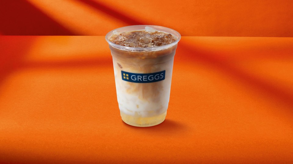 a cup of greggs sits on an orange table