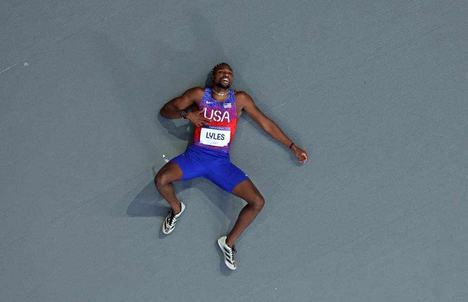 a runner from the usa is laying on the ground