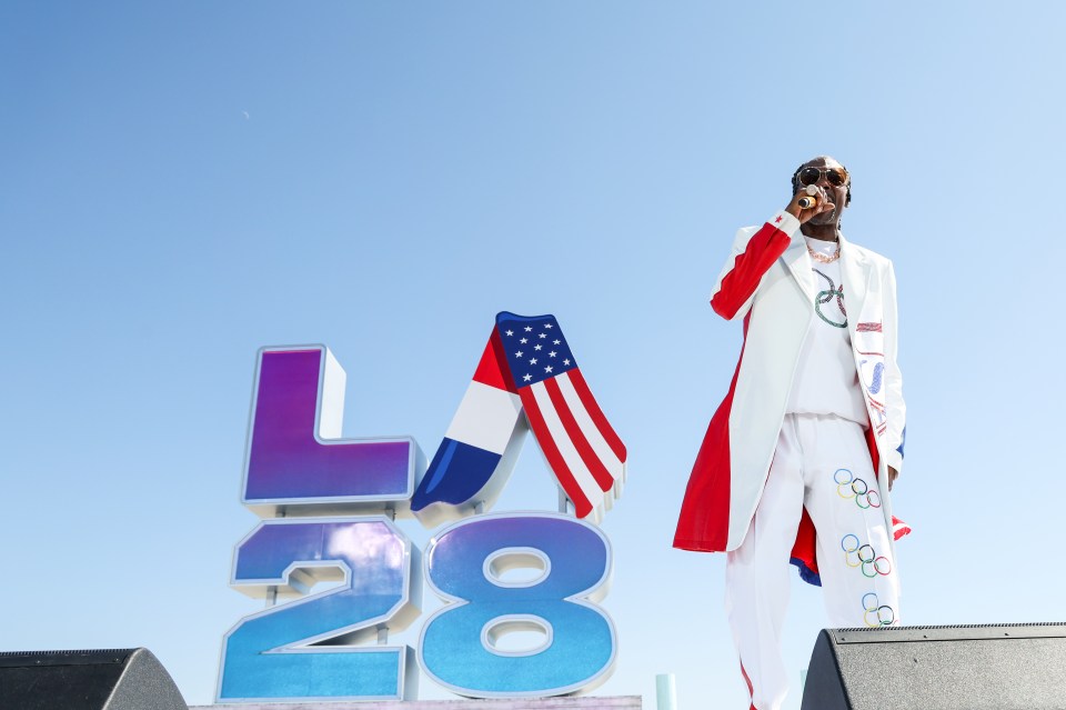 a man stands in front of a sign that says la 28