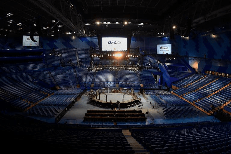 an empty ufc stadium with blue seats