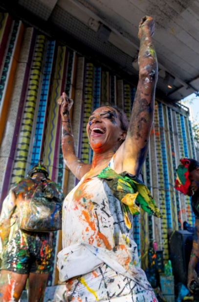 Revellers throw paint at each other in the street at the festival