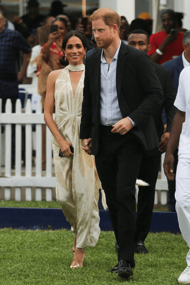 a man in a suit and a woman in a white dress are holding hands