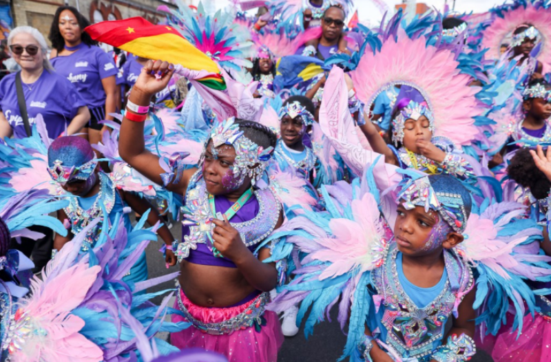 Dancers and children parade on Family Day at the 56th Notting Hill Carnival in west London