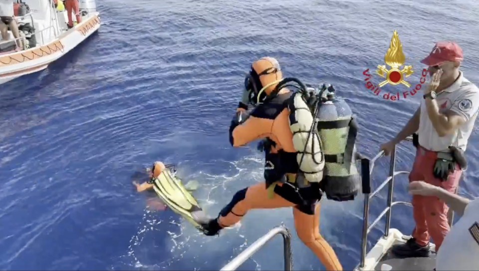 Divers jumping in the sea off the Porticello coast as the scour the wreckage