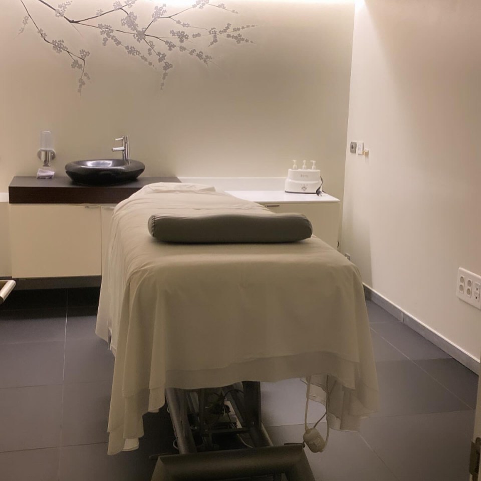 a massage table in a room with a sink