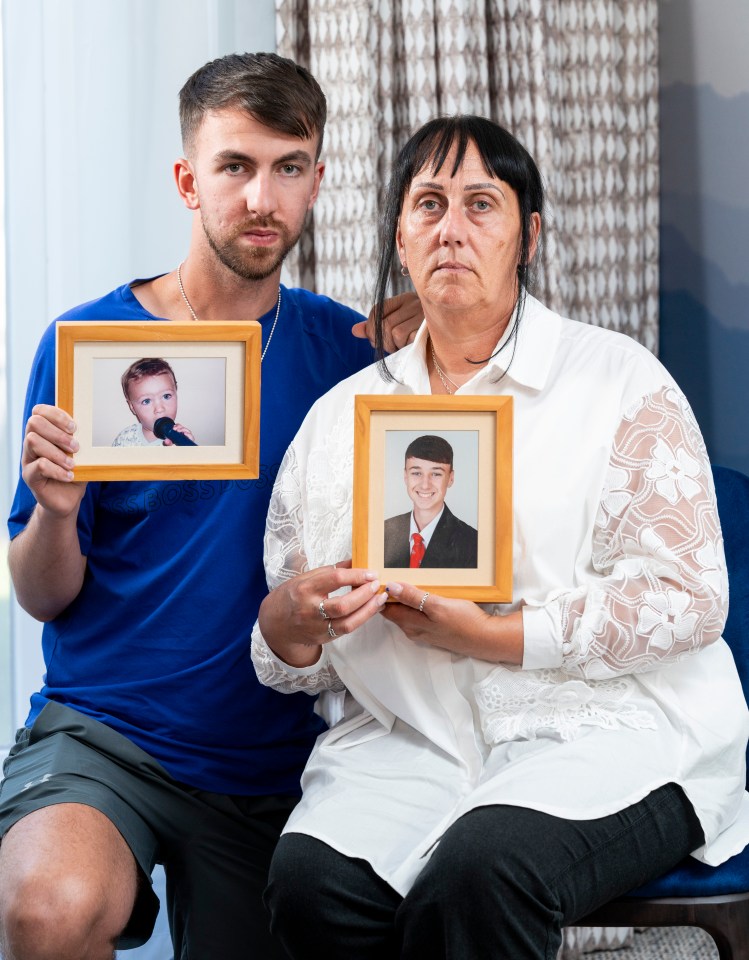 a man and a woman holding framed pictures of a baby and a man