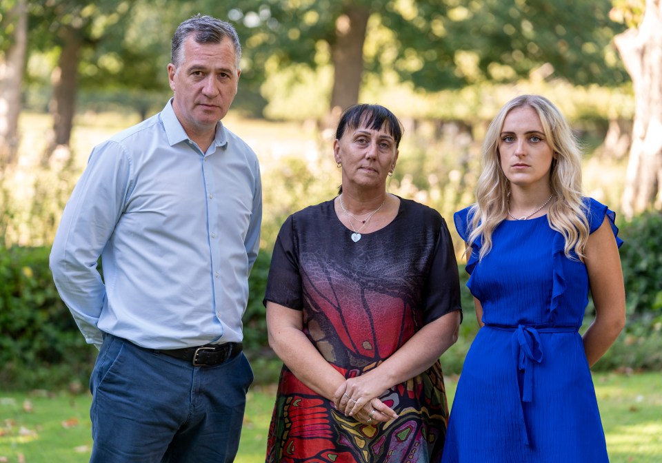 a man and two women standing next to each other in a park