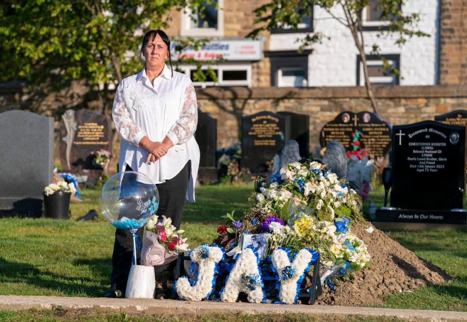 Debbie beside her beloved son's grave in Accrington, Lancs