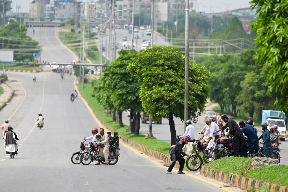 a group of people are riding motorcycles down a street