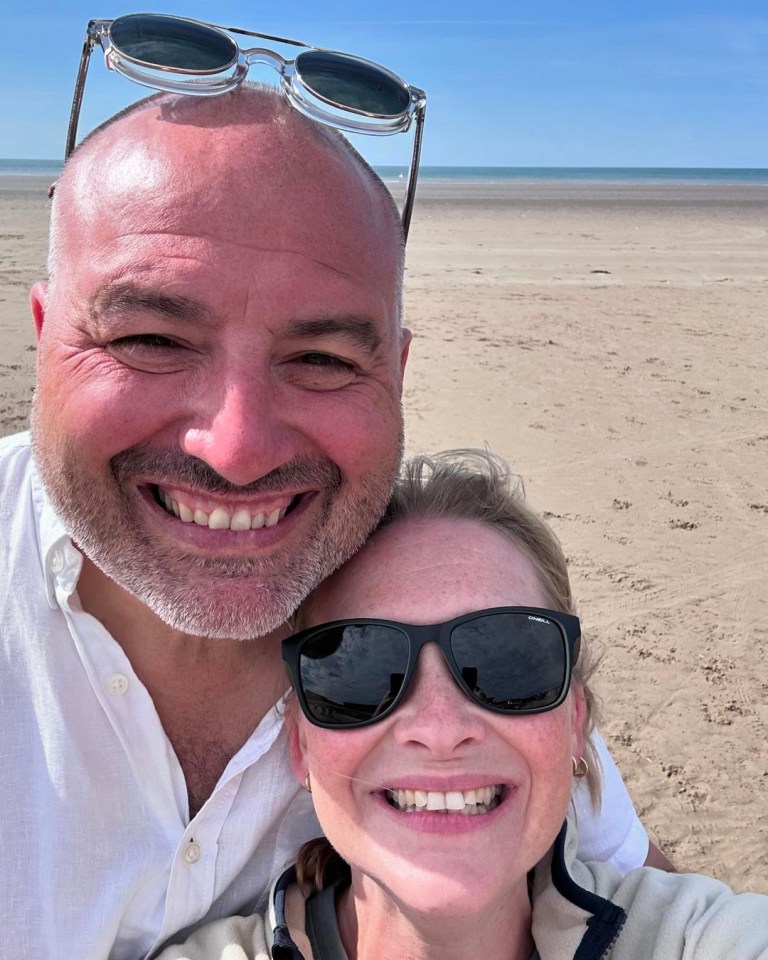 a man and a woman wearing sunglasses are posing for a picture on the beach