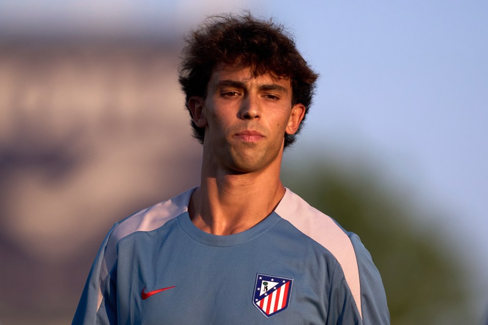 a man wearing a blue shirt with a red white and blue logo on it