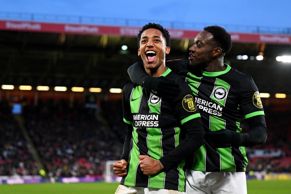 two soccer players wearing green and black jerseys that say american express