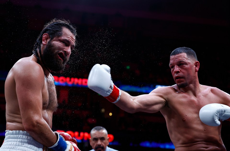 two men are boxing in front of a sign that says round