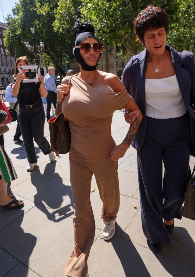 a woman with a bandage on her head walks down the street